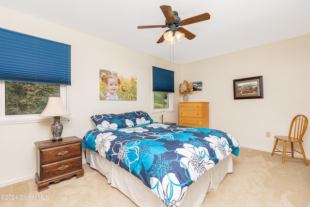 carpeted bedroom with baseboards and ceiling fan