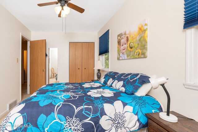 bedroom featuring a ceiling fan, a closet, and visible vents