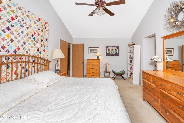 bedroom featuring high vaulted ceiling, a ceiling fan, and light colored carpet