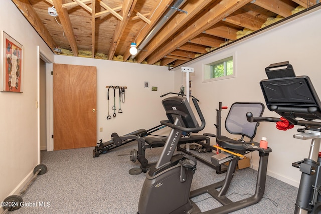 workout area featuring baseboards and carpet