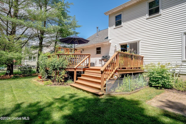 rear view of property featuring fence, a wooden deck, a shingled roof, and a yard