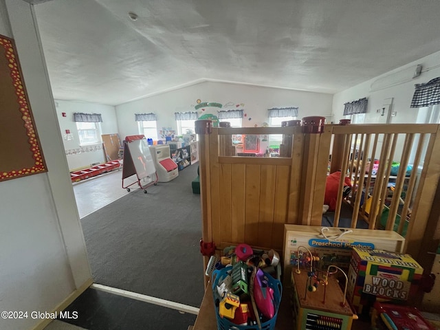 rec room with carpet floors and vaulted ceiling