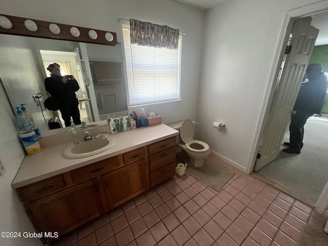 bathroom featuring tile patterned floors, vanity, and toilet