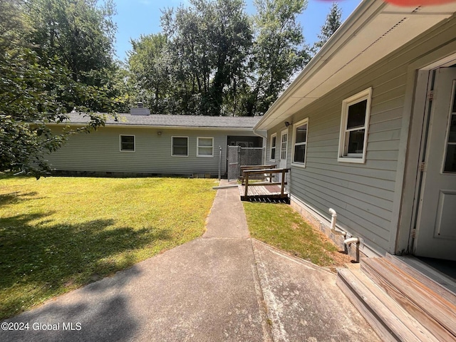 exterior space with a yard and a wooden deck