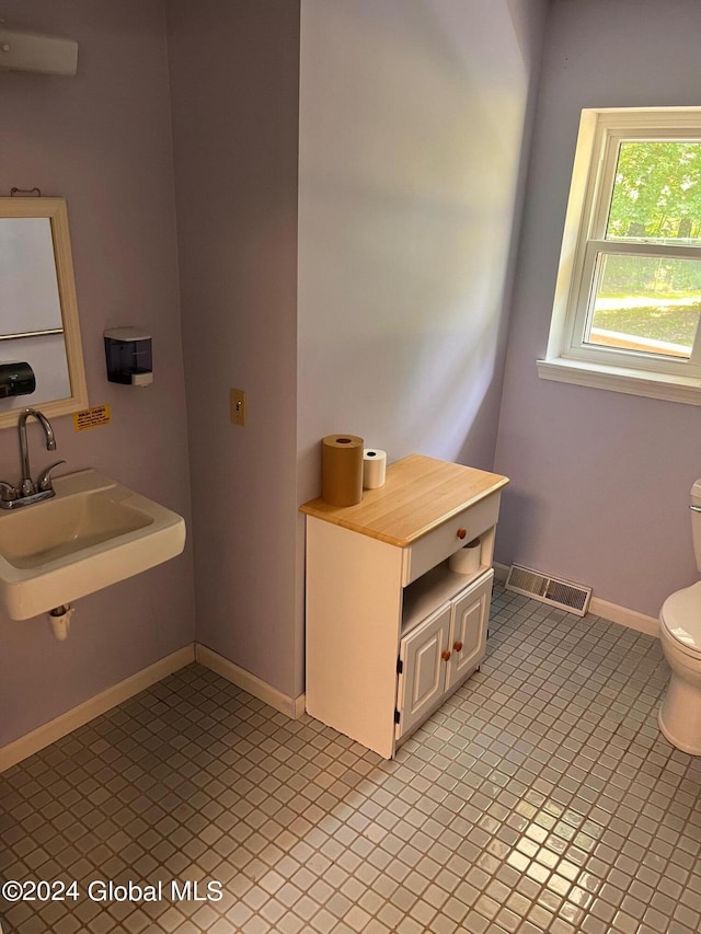 bathroom featuring tile patterned floors, toilet, and sink