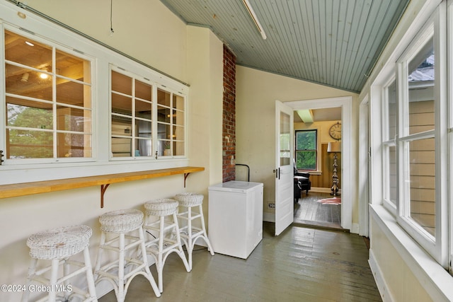 exterior space with dark hardwood / wood-style flooring and wood ceiling