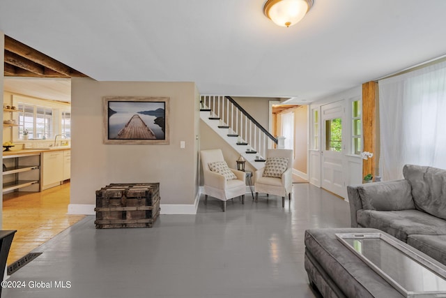 living room with beamed ceiling and hardwood / wood-style flooring