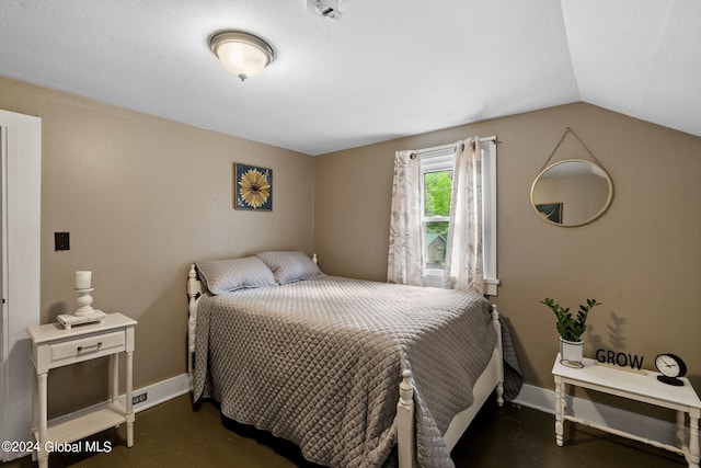 bedroom with lofted ceiling and dark hardwood / wood-style flooring