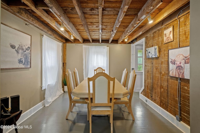 dining space featuring wood-type flooring, wooden ceiling, and beamed ceiling