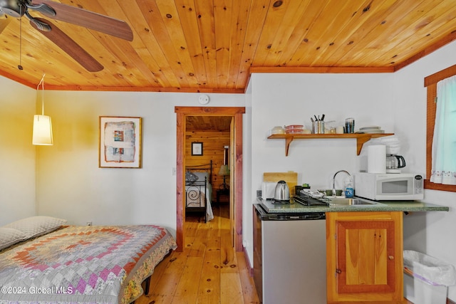 bedroom featuring wooden ceiling, sink, and light hardwood / wood-style floors