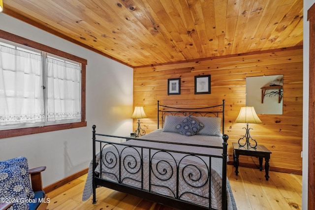 bedroom featuring wood walls, light wood-type flooring, and wood ceiling