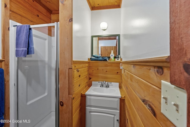 bathroom featuring a shower with shower door and oversized vanity