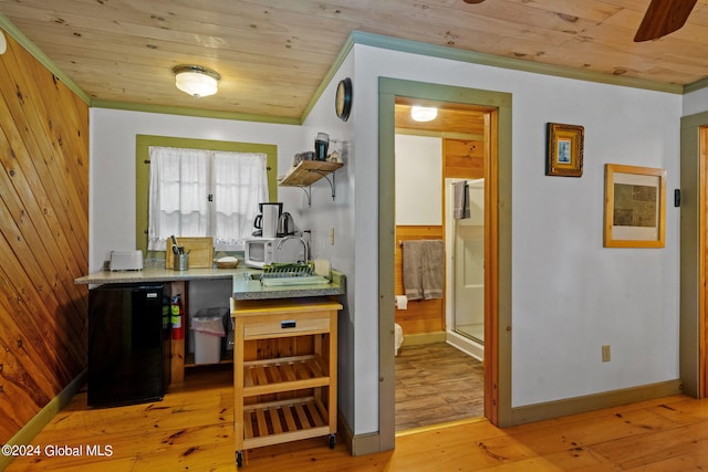 kitchen with ornamental molding, wooden ceiling, hardwood / wood-style flooring, fridge, and ceiling fan