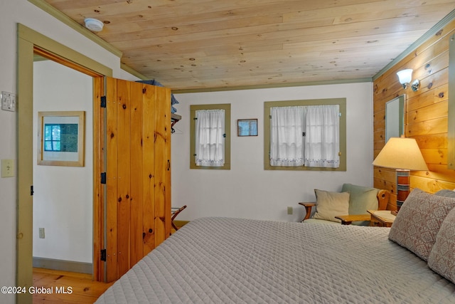 bedroom featuring wooden ceiling, hardwood / wood-style flooring, and vaulted ceiling