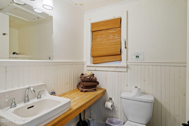 bathroom with sink, ornamental molding, and toilet