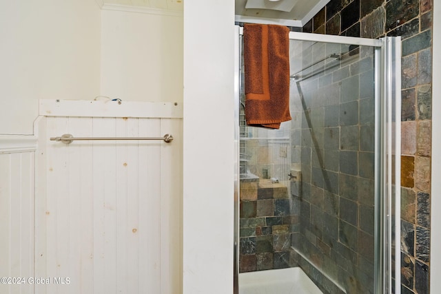 bathroom featuring a shower with shower door