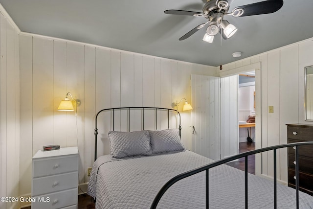 bedroom with dark hardwood / wood-style flooring and ceiling fan