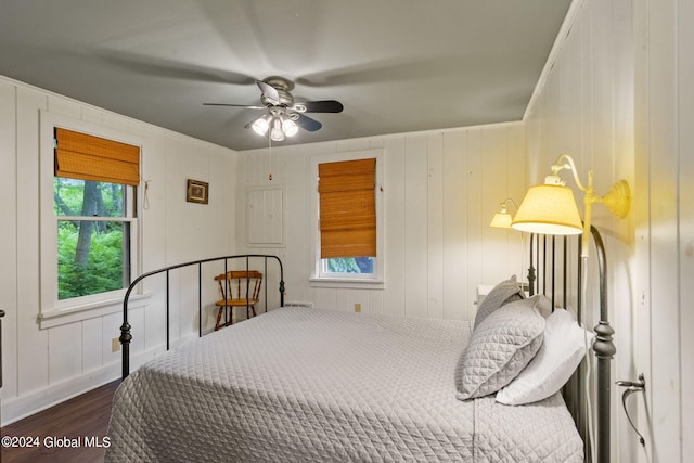 bedroom with ceiling fan, hardwood / wood-style flooring, and multiple windows