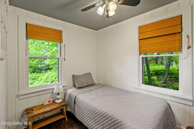 bedroom featuring hardwood / wood-style floors, multiple windows, and ceiling fan