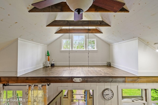 bonus room featuring hardwood / wood-style floors, lofted ceiling with beams, and ceiling fan