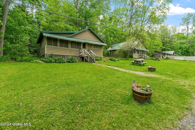 view of yard featuring a sunroom