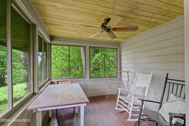 unfurnished sunroom with a healthy amount of sunlight, wood ceiling, and ceiling fan