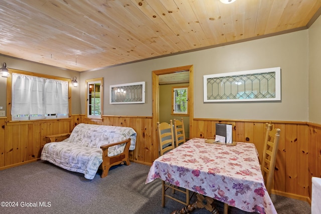 bedroom with wood ceiling, carpet floors, and multiple windows