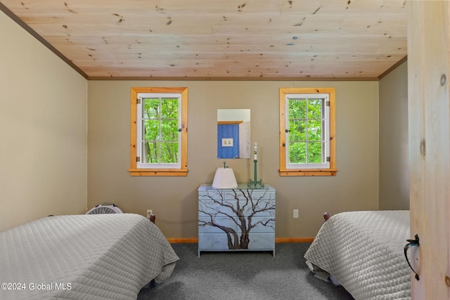 carpeted bedroom with wood ceiling