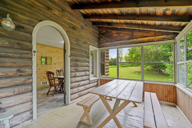 unfurnished sunroom featuring wooden ceiling and lofted ceiling with beams