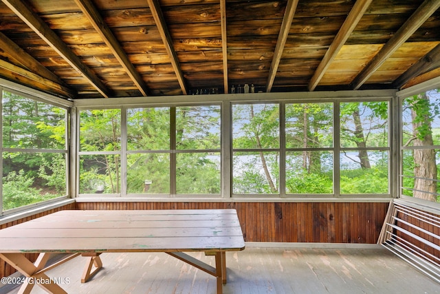 unfurnished sunroom featuring vaulted ceiling and wood ceiling