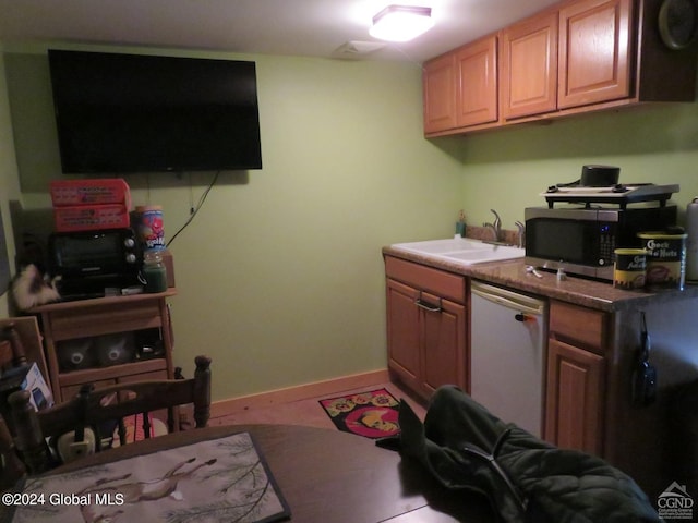 kitchen featuring sink and dishwashing machine