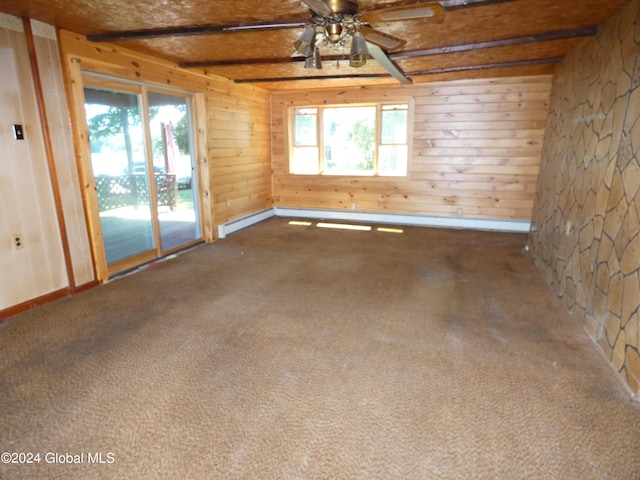 empty room featuring beam ceiling, ceiling fan, carpet floors, and baseboard heating