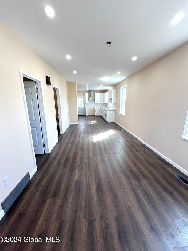 unfurnished living room with dark hardwood / wood-style floors