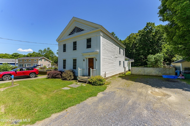 greek revival inspired property featuring a front yard