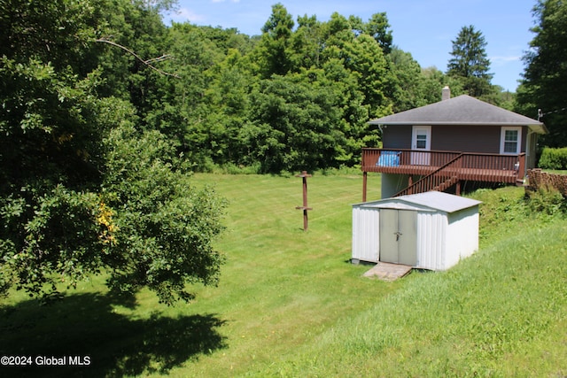 view of yard featuring a deck and a storage unit