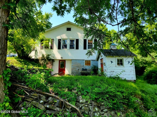 split level home featuring an outbuilding