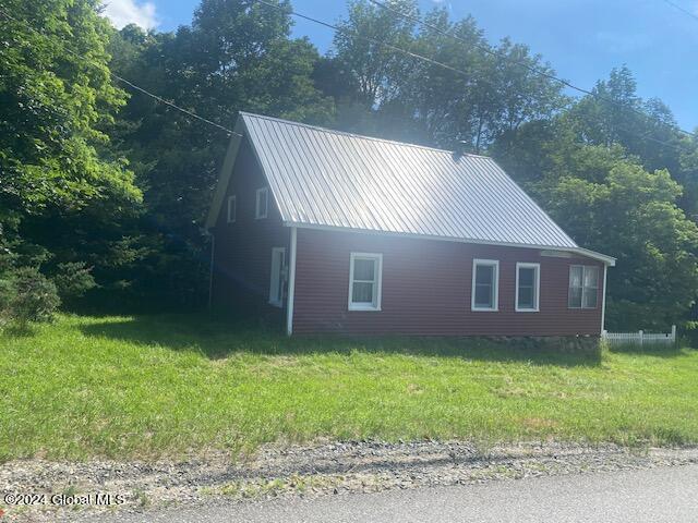 302 Edwards Hill Rd, Johnsburg, NY 12811 - view of side of home featuring a lawn