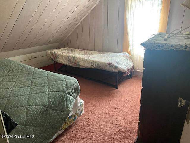 302 Edwards Hill Rd, Johnsburg, NY 12811 - carpeted bedroom featuring lofted ceiling and wooden walls