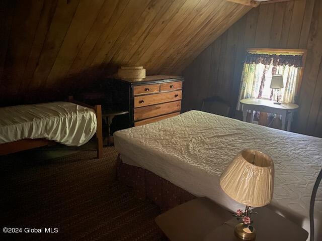 302 Edwards Hill Rd, Johnsburg, NY 12811 - bedroom featuring wooden walls, wooden ceiling, and lofted ceiling