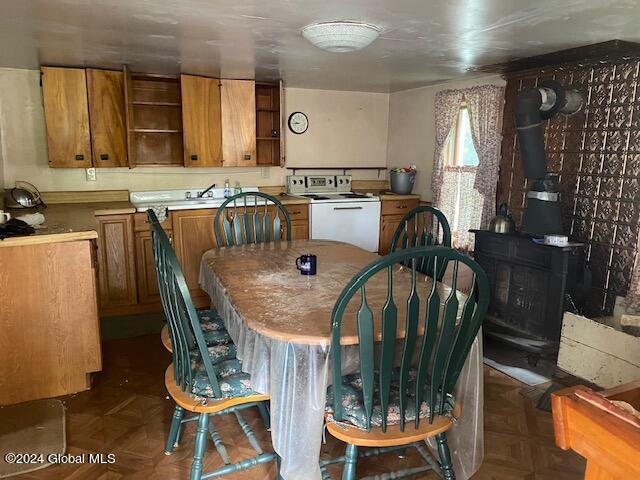 302 Edwards Hill Rd, Johnsburg, NY 12811 - dining room with dark parquet floors and a wood stove