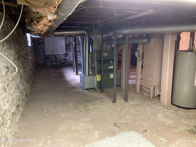 basement featuring heating unit and water heater