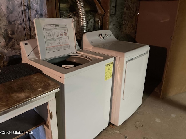 clothes washing area featuring washer and dryer