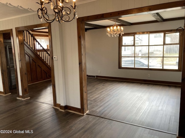 interior space with ornamental molding, a notable chandelier, beam ceiling, and dark wood-type flooring