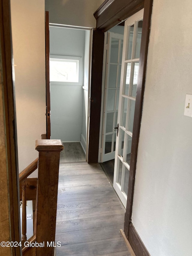 hallway featuring hardwood / wood-style flooring and french doors