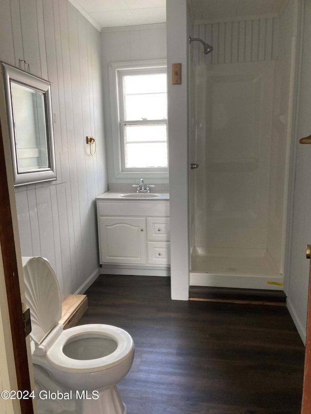 bathroom with walk in shower, toilet, vanity, and hardwood / wood-style floors