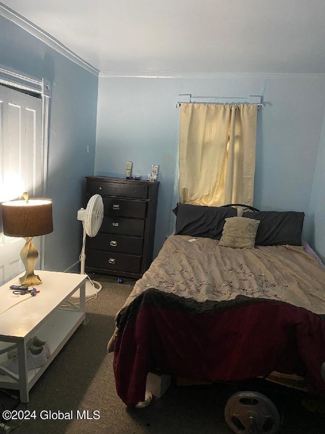 carpeted bedroom featuring crown molding