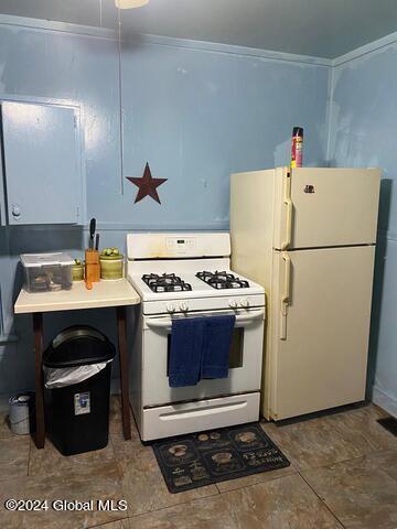 kitchen with crown molding and white appliances