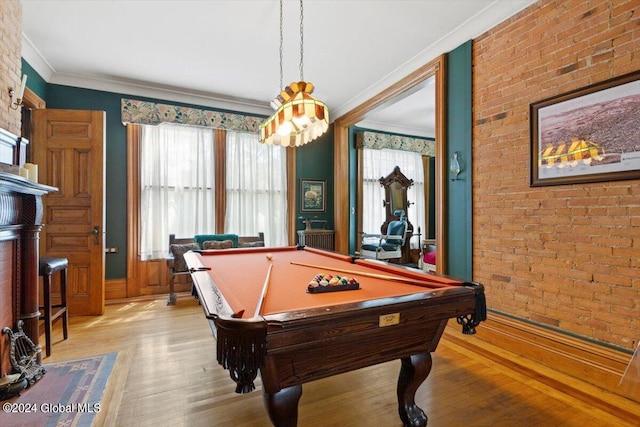 rec room featuring pool table, light hardwood / wood-style flooring, brick wall, and ornamental molding