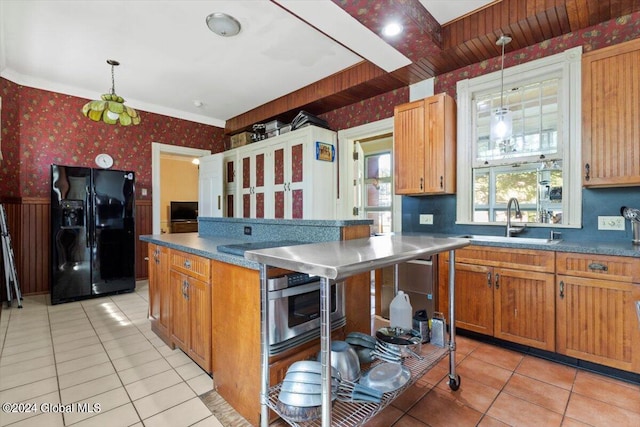 kitchen featuring sink, light tile patterned floors, pendant lighting, and black refrigerator with ice dispenser