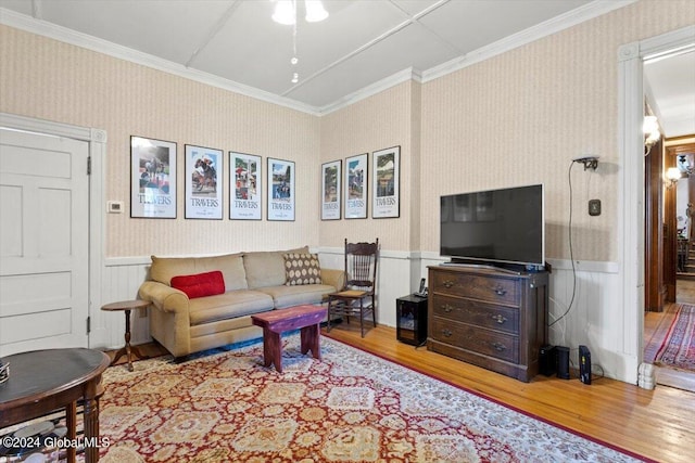 living room featuring wood-type flooring and ornamental molding